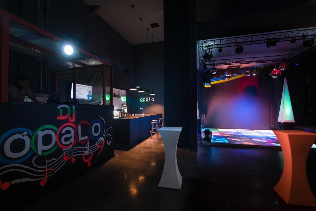 Impressive Punta Cana Exterior foto The photo shows the interior of a venue that appears to be a nightclub or party space. On the left side, there's a bar or DJ booth with the name "DJ Opalo" displayed prominently. The area features modern lighting and a dance floor with colorful light